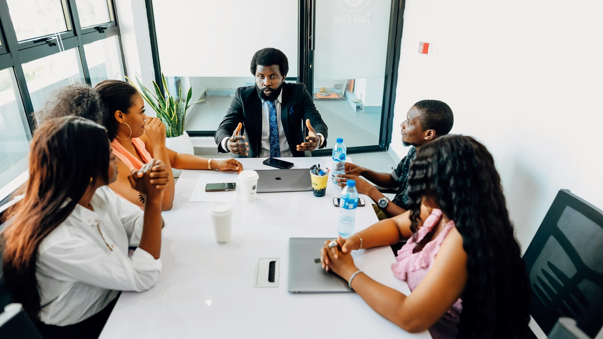 A group of people sitting around a white table